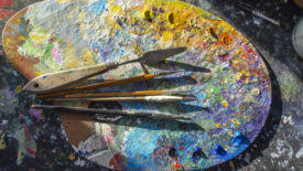Photo of an artist's palette with many colors of paint
