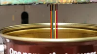 Photo of colorant being added to a can of HMG base paint