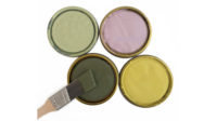 Image of four paint can lids with the Miller Paint 2022 Spring colors, including a moss green, a yellow-green, a rose color, and a light green.
