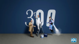 Image of a painter, a scientist and an explorer standing in front of a large sign that says "300"