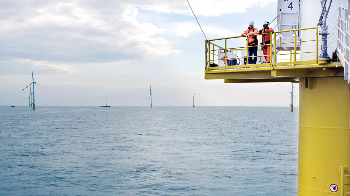 Two workers at an offshore wind farm in the North Sea.