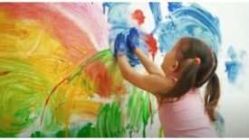 Photo of child painting a mural