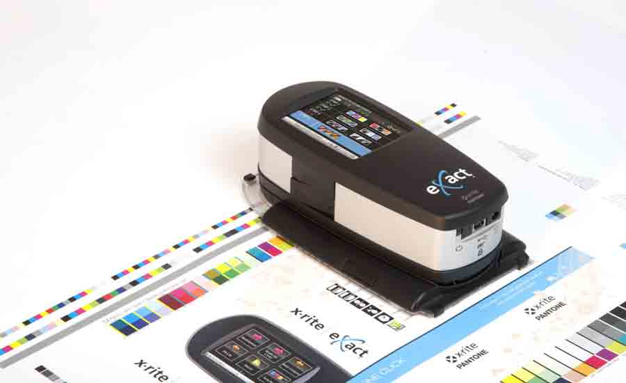 An X-Rite eXact spectrophotometer reading color patches on a press sheet.