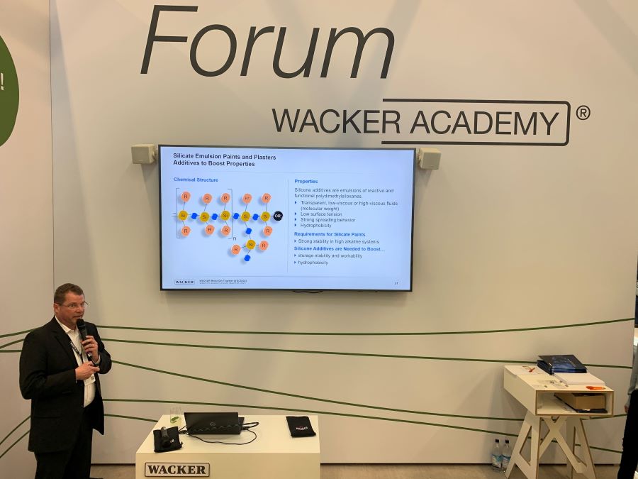 Wacker chemist giving presentation at the booth.